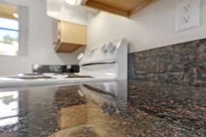 New dark granite counter tops in kitchen in Arezzo unit at Sienna Senior Apartments