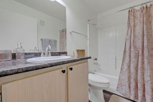 The Florence unit in Sienna Senior Apartments second bathroom with large mirror, private restroom and walk in shower